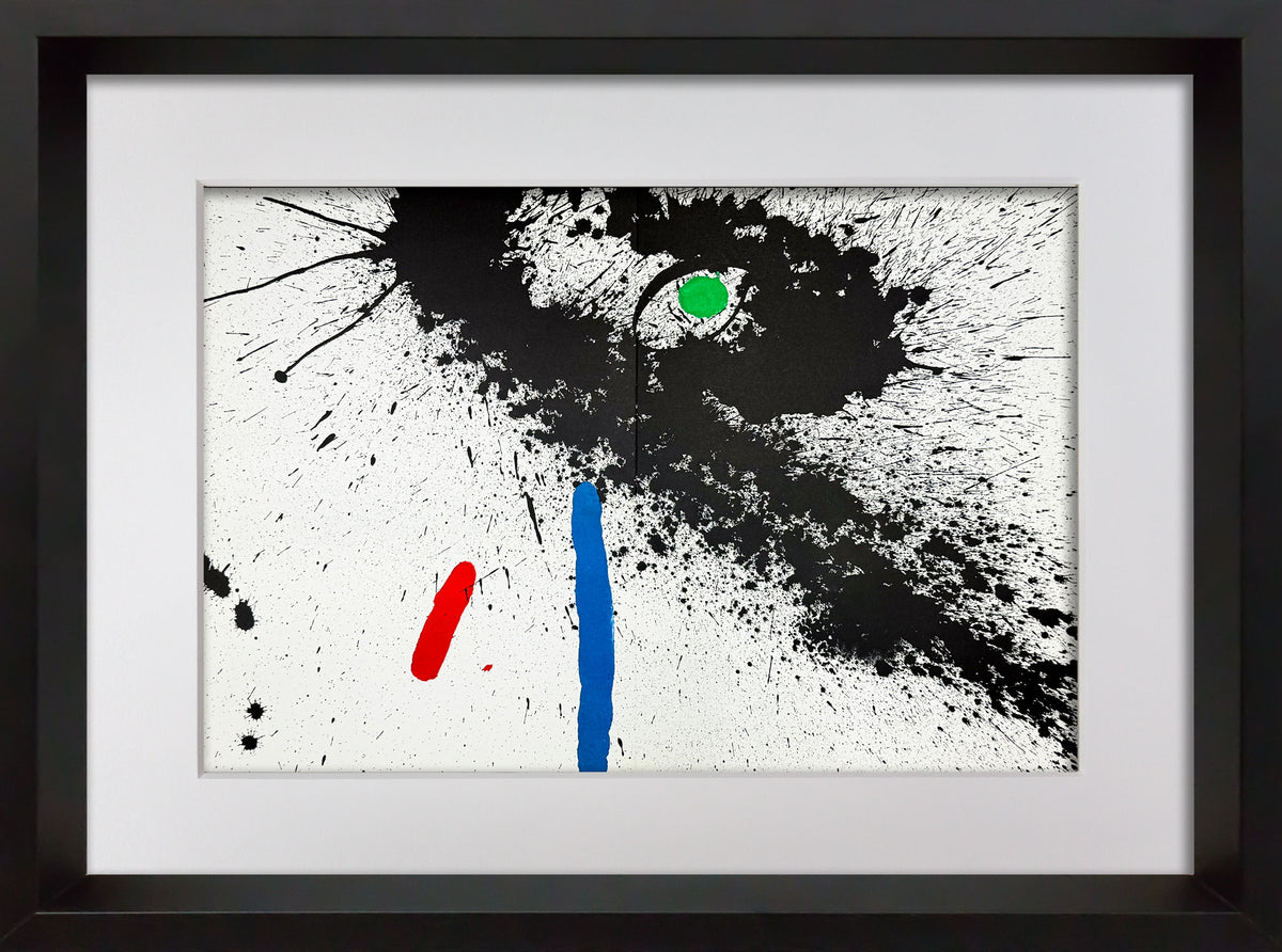 Framed abstract Joan Miro wall art featuring a black ink splash and splatter pattern on a white background, with a vertical blue stroke, a red curved stroke, and a small green oval, shown in a black frame with white mat.