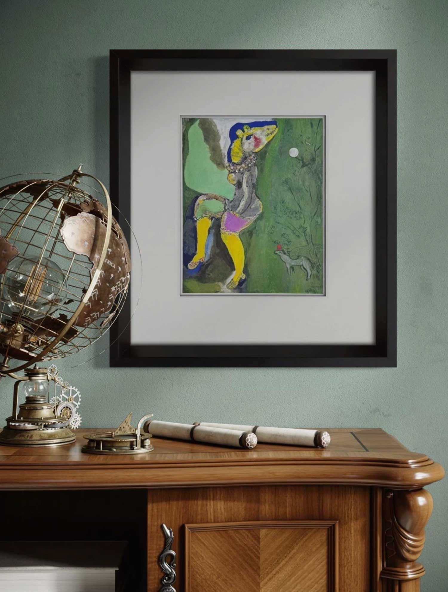 Framed Marc Chagall Lithograph on a wall above a wooden desk with decorative items.