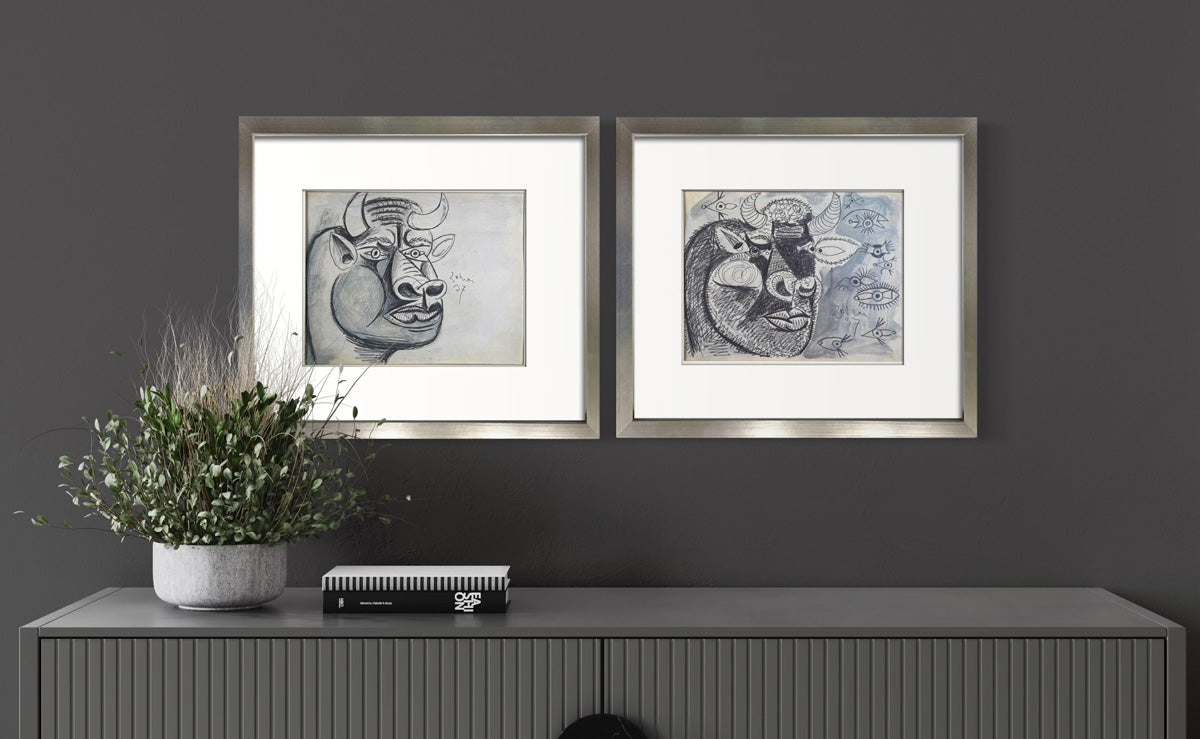 Framed Pablo Picasso Guernica bull study lithographs, limited edition set of two, displayed above a console table