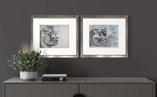Framed Pablo Picasso Guernica bull study lithographs, limited edition set of two, displayed above a console table